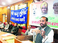 Senior BJP leader Ravinder Jugran addresses a gathering on Balidan Divas in Mussoorie