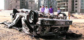 The remains of a police Gypsy that was set on fire in Gurgaon on Friday.