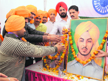 Youths pay floral tributes to Shaheed Bhagat Singh in Jammu on Friday. 