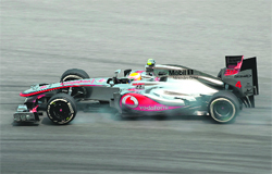 McLaren-Mercedes Lewis Hamilton powers his car during a practice session of Formula One Malaysian GP in Sepang on Friday. 