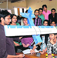 Students display a model of a glider during the Aerotrik show organised at the Punjab Engineering College in Chandigarh on Saturday