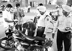 Police officials check a motorcycle during a naka at Sector 37 in Chandigarh on Saturday