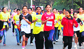 Girls take part in a marathon at Sukhna Lake in Chandigarh on Sunday. 