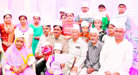 A Haridwar-based family sits on a one-day fast in support of the Jantar Mantra fast by Anna Hazare in remembrance of the anti-corruption martyrs in Haridwar on Sunday.