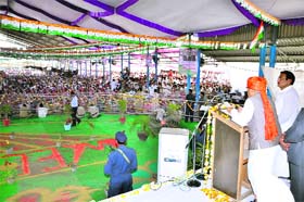 Chief Minister Bhupinder Singh Hooda addresses a rally at Rania on Sunday as former minister and rally organiser Ranjit Singh looks on