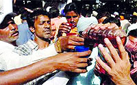 Liquor being distributed among devotees at Baba Rode Shah mela in Bhoma Wadala