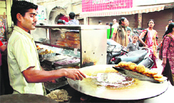 A worker prepares tikkis at Kwality Chat Corner in Jalandhar.
