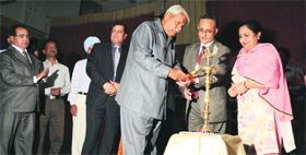Ex-DGP (Haryana cadre) P Wadhwa lights a lamp during an Alumni Association meet of SCD Government College in Ludhiana on Sunday.