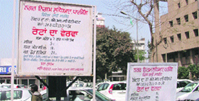 A board displaying parking rates at Feroze Gandhi Market in Ludhiana.