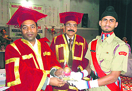 Anil Dhantori, MLA, Shahabad-Markanda (extreme left) and Dr Vinay Malhotra (centre), principal, MN College, Shahabad-Markanda, give away the Best NCC Cadet Award to Tarsem Singh, under-officer, NCC, during a function held at the college premises in Kurukshetra. 