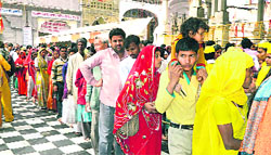 Pilgrims await their turn to pay obeisance at the Brajeshwari Devi temple in Kangra on Monday. 