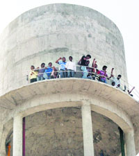Students atop a water tank in Jaitu. 