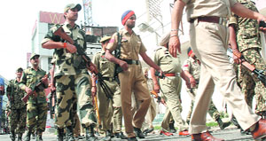 BSF and police personnel take out a flag march in Jalandhar on Monday.