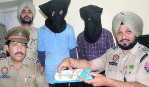 The accused with the recovered gold ornaments in police custody in Jalandhar on Monday. 