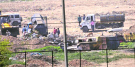 Solid waste being dumped by the municipal corporation on government land near the Tawi riverbed in Jammu.
