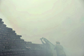 Fire Brigade officials try to douse the flames at a factory in the Dhandari area in Ludhiana on Monday. 