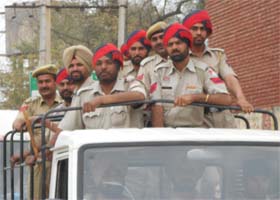 Police jawans on a police Gypsy during the flag march in Fazilka on Tuesday