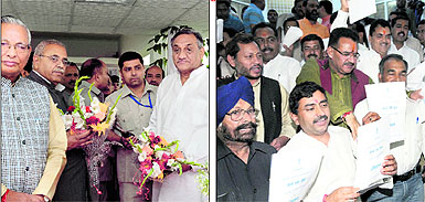 Assembly Speaker Govind Singh Kunjwal (left), former Speaker Harbans Kapoor and Chief Minister Vijay Bahuguna wait for the Governor for the inaugural address to the new state Assembly in Dehradun on Tuesday; and (right) BJP legislators hold a protest against the Governors address in English