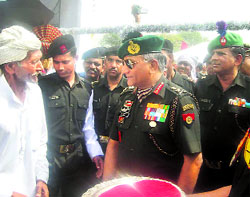 The Army chief, Gen VK Singh, talks to an elderly man at a medical camp held at Bapora village in Bhiwani district on Tuesday. 