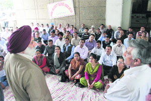 Jammu University VC Prof MPS Ishar talks to the teachers protesting in front of the Administrative Block in Jammu on Tuesday. 