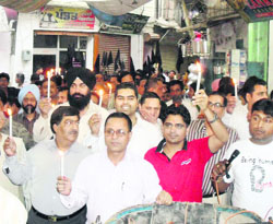 Jewellers of Jagraon carry out a candle march in protest of excise duy on non-branced gold on Tuesday