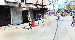 Youngsters play cricket on deserted roads in Amritsar on Wednesday