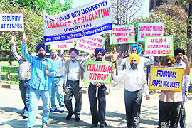 Teachers take out a protest rally on the GND University campus in Amritsar on Wednesday