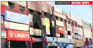 Hoardings put up outside showrooms at Sector 11 in Panchkula. 