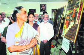 Governor Margaret Alva sees paintings at an exhibition in Dehradun on Wednesday