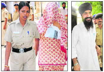 Accused Ravdeep Kaur and Manjit Singh come out of the district courts in Chandigarh on Wednesday.