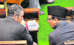Chief Minister Omar Abdullah discusses a point with Finance Minister Abdul Rahim Rather in the Assembly on Wednesday.