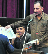 Panthers Party MLC Rafiq Shah displays a copy of Jammu Tribune in House