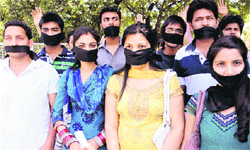 ABVP members hold a silent protest at PU Vice-Chancellors office in Chandigarh on Thursday.