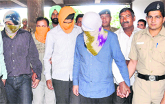 The accused in police custody at Chandigarh. tribune photo