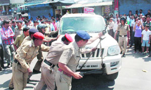 Policemen take away a vehicle driven by four drunken youths