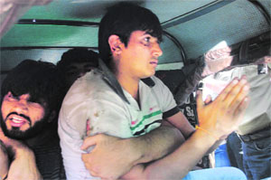 The Delhi-based youths after being beaten up by a mob at Dilaram Chowk in Dehradun on Thursday.