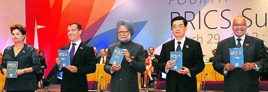 Brazilian President Dilma Rousseff, Russian President Dmitry Medvedev, Indian Prime Minister Manmohan Singh, Chinese President Hu Jintao and South African President Jacob Zuma hold copies of the BRICS report after its release during a plenary session of the summit in New Delhi on Thursday