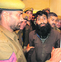 The escaped militant Sher Khan in police custody in Ramban district.