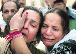 Family members of 19-year-old Mannu, who was murdered by a drug addict in the Nai Basti area, wail after they visited the Gandhi Nagar police station in Jammu on Thursday
