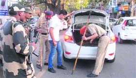 Security personnel check vehicles