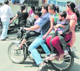 Flouting norms, a family of five rides a motorcycle in Jalandhar on Thursday