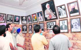 Visitors watch the pictures of Ghadarites at Ghadari Baba Comrade Bhagat Singh Bilga Memorial Hall at Bilga village, near Jalandhar