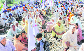 Farmers and their family members during a protest seeking waiver of loans near Amritsar on Thursday.