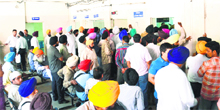 Applicants throng the office of tehsildar at the district courts complex to get their properties registered in Amritsar on Friday.