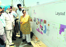 Minister for Tourism and Culture Sarwan Singh Phillaur checks out the map of the heritage village at Guru Nanak Dev University in Amritsar on Friday. 