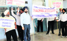 Teachers of Guru Nanak Dev University protest on the campus in Amritsar on Friday. 