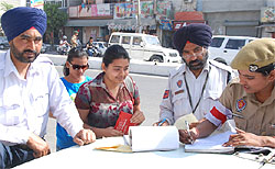 Traffic policemen issue a challan to a violator of the traffic rules in Bathinda on Friday
