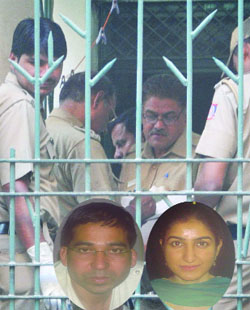 Policemen investigate the Defence Colony residence of a defence ministry official and his wife who were found dead on Friday. 
