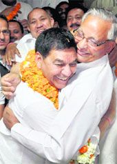 Uttarakhand Assembly Speaker Govind Singh Kunjwal congratulates Mahendra Singh Mahra in Dehradun on Friday