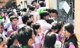 Students gather at the office of DAV PG College to get the errors rectified in Dehrdaun on Friday.